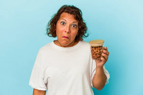 Young Mixed Race Woman Holding Almond Jar Isolated Blue Background — Fotografia de Stock