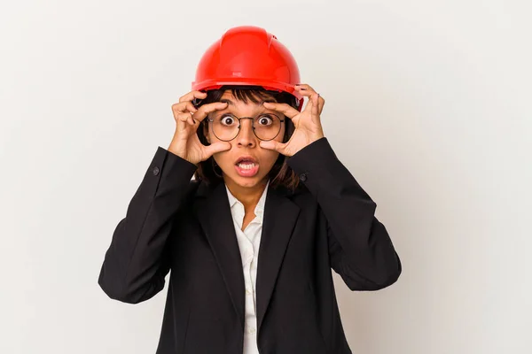 白い背景に隔離された赤いヘルメットを持つ若い建築家の女性は目を開いて成功の機会を見つける — ストック写真