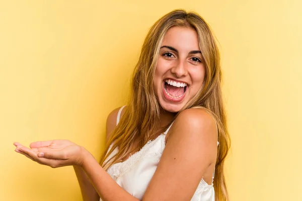 Young Caucasian Blonde Woman Isolated Yellow Background Holding Copy Space — Stock Photo, Image