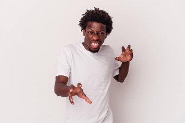 Beyaz arka planda izole edilmiş genç Afro-Amerikalı bir adam pençelerini kedi taklidi yaparken gösteriyor, agresif bir hareket..