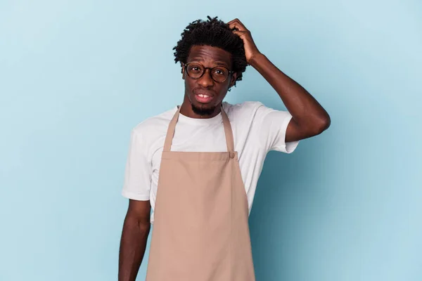 Young African American Store Clerk Isolated Blue Background Being Shocked — Stock Photo, Image