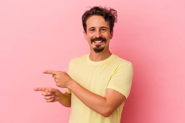 Young Caucasian Man Isolated Pink Background Excited Pointing Forefingers Away — Stock Photo, Image