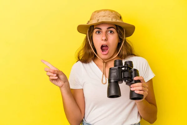 Ung Kaukasisk Kvinna Som Håller Kikare Isolerade Gul Bakgrund Pekar — Stockfoto