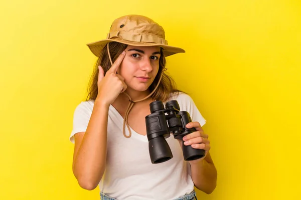 Young Caucasian Woman Holding Binoculars Isolated Yellow Background Pointing Temple — Stock Photo, Image