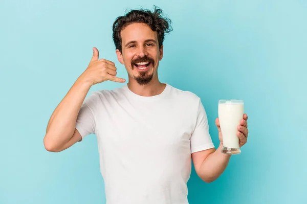 Young Caucasian Man Holding Glass Milk Isolated Blue Background Showing — 图库照片