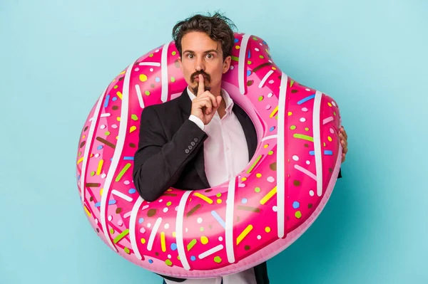 Young Business Man Inflatable Donut Isolated Blue Background Keeping Secret — 图库照片