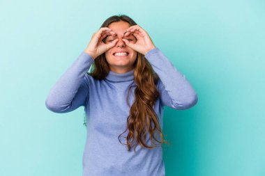 Mavi arka planda izole edilmiş beyaz bir kadın gözlerinde sorun olmadığını gösteriyor.