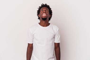 Beyaz arka planda izole edilmiş genç Afro-Amerikalı adam çok kızgın, öfkeli, hayal kırıklığına uğramış diye bağırıyor..