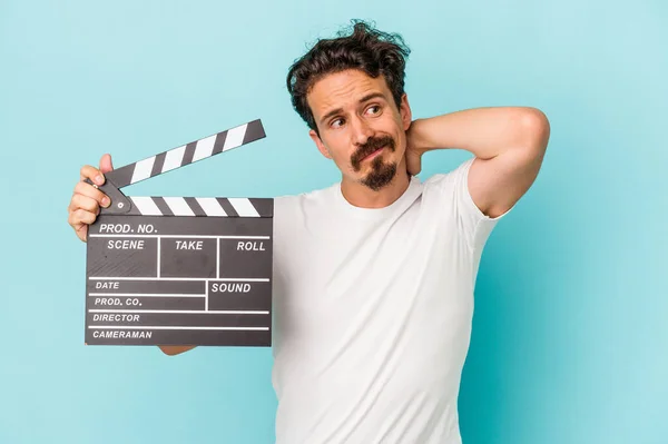 Young Caucasian Man Holding Clapperboard Isolated Blue Background Touching Back — Stock Photo, Image
