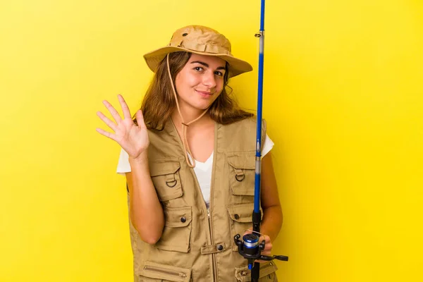 Young Caucasian Fisherwoman Holding Rod Isolated Yellow Background Smiling Cheerful — Stock Photo, Image