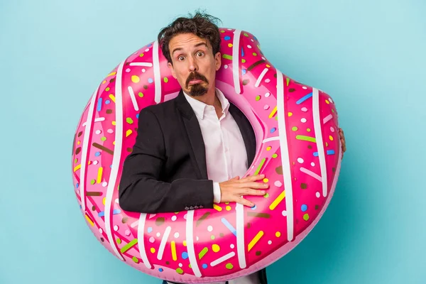 Young Business Man Inflatable Donut Isolated Blue Background Shrugs Shoulders — 图库照片