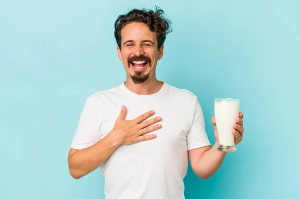 Young Caucasian Man Holding Glass Milk Isolated Blue Background Laughs — 图库照片