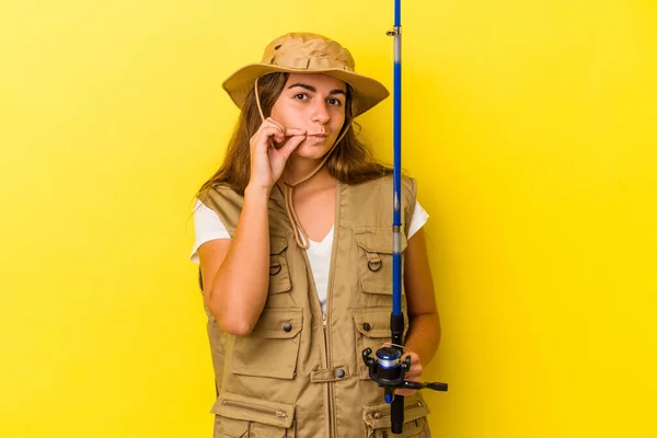 Young Caucasian Fisherwoman Holding Rod Isolated Yellow Background Fingers Lips — Stock Photo, Image