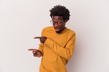 Beyaz arka planda izole edilmiş genç bir Afrikalı Amerikalı işaret parmağıyla fotokopi alanını işaret ederek heyecan ve arzusunu ifade ediyor..