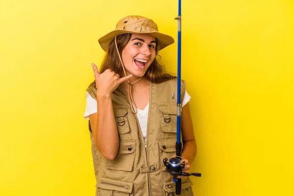 Young Caucasian Fisherwoman Holding Rod Isolated Yellow Background Showing Mobile — Stock Photo, Image