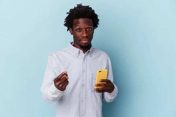 年轻的非洲裔美国人 手持蓝色背景的手机 用手指指着你 好像在邀请你走近些 — 图库照片