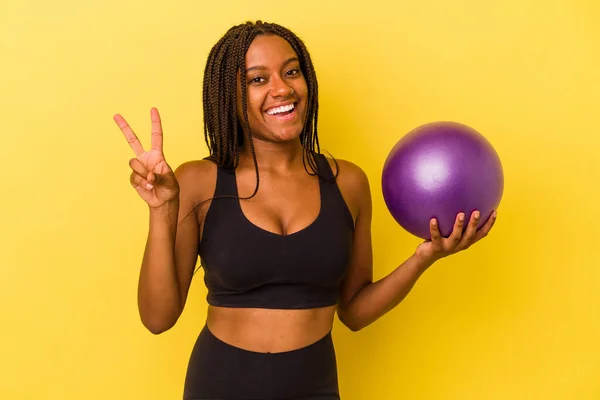 Young African American Woman Holding Pilates Ball Isolated Yellow Background — Stock Photo, Image