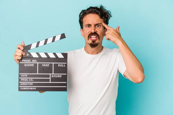 Young Caucasian Man Holding Clapperboard Isolated Blue Background Showing Disappointment — Stock Photo, Image