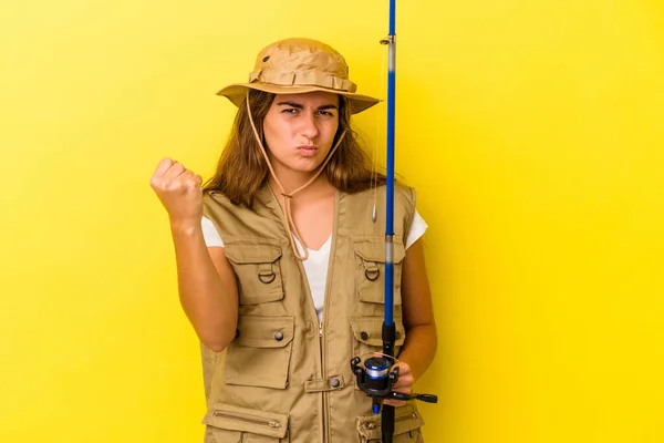 Young Caucasian Fisherwoman Holding Rod Isolated Yellow Background Showing Fist — Stock Photo, Image