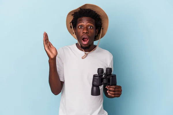 Young African American Man Holding Binoculars Isolated Blue Background Surprised — ストック写真