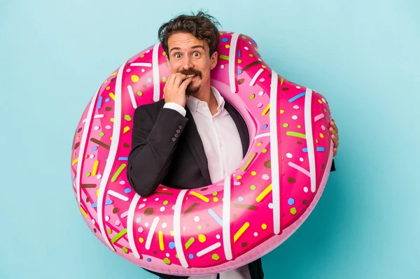 Young Business Man Inflatable Donut Isolated Blue Background Biting Fingernails — 图库照片