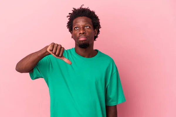年轻的非洲裔美国人 因粉红的背景而被隔离 表现出不喜欢的姿态 大拇指垂下 不同意的概念 — 图库照片