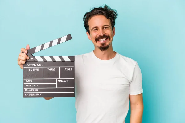 Young Caucasian Man Holding Clapperboard Isolated Blue Background Happy Smiling — Stock Photo, Image