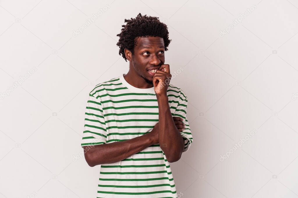 Young african american man isolated on white background  relaxed thinking about something looking at a copy space.
