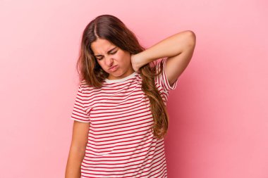 Genç, beyaz bir kadın pembe arka planda izole edilmiş. Durağan yaşam tarzından dolayı boyun ağrısı çekiyor..