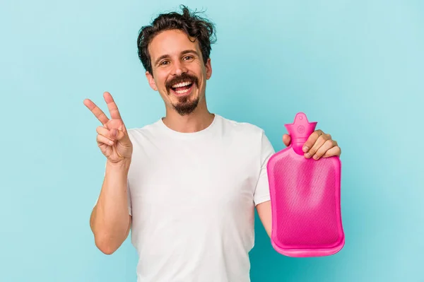 Young Caucasian Man Holding Water Bag Isolated Blue Background Joyful — 图库照片