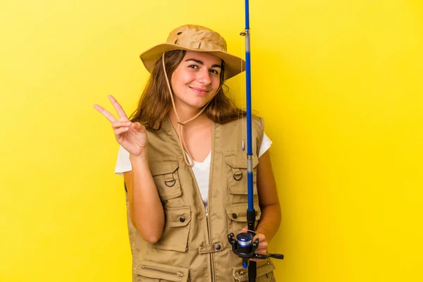 Young Caucasian Fisherwoman Holding Rod Isolated Yellow Background Showing Number — Stock Photo, Image