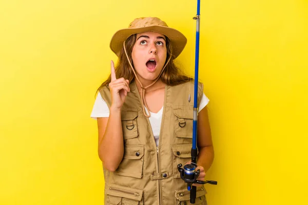 Young Caucasian Fisherwoman Holding Rod Isolated Yellow Background Pointing Upside — Stock Photo, Image