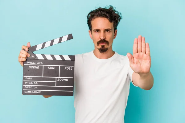 Young Caucasian Man Holding Clapperboard Isolated Blue Background Standing Outstretched — Stock Photo, Image