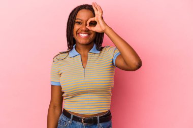 Genç Afro-Amerikalı kadın pembe arka planda izole edilmiş. Heyecanlı..