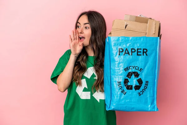 Young Caucasian Woman Recycled Paper Isolated Pink Background Shouting Holding — Zdjęcie stockowe