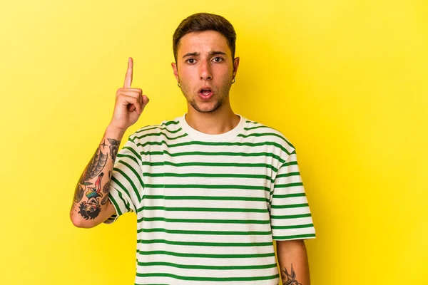 Young Caucasian Man Tattoos Isolated Yellow Background Pointing Upside Opened —  Fotos de Stock