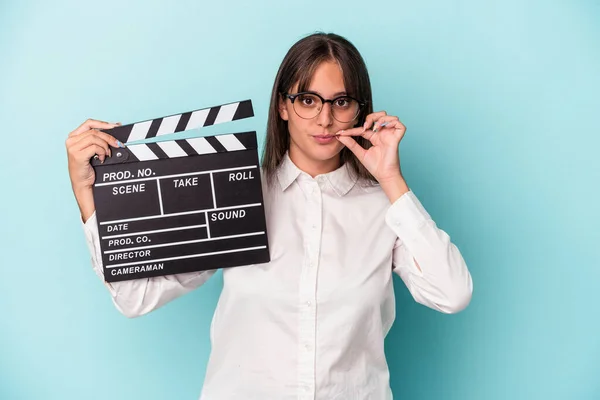 Young Caucasian Woman Holding Clapperboard Isolated Blue Background Fingers Lips — 图库照片