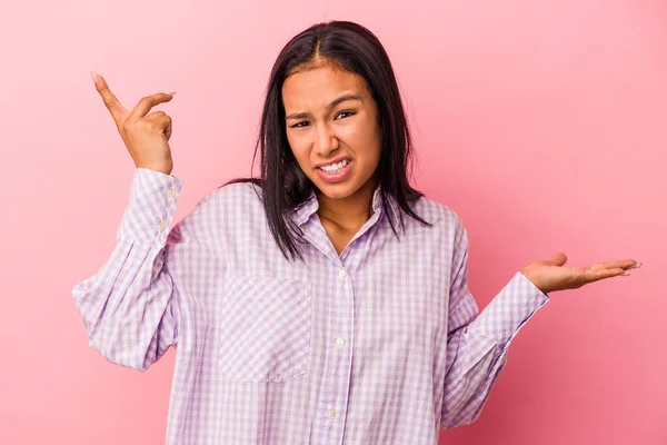 Jonge Latijnse Vrouw Geïsoleerd Roze Achtergrond Houden Tonen Een Product — Stockfoto