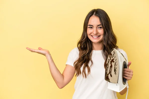 Young Caucasian Woman Holding Iron Isolated Yellow Background Showing Copy — 스톡 사진