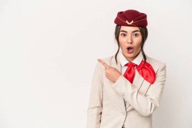 Young caucasian stewardess woman isolated on white background pointing to the side