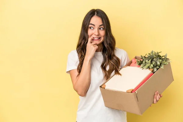 Young caucasian woman making a move isolated on yellow background relaxed thinking about something looking at a copy space.