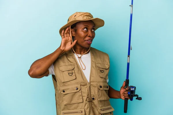 Young African American Fisherwoman Holding Rod Isolated Blue Background Trying — Stock Photo, Image