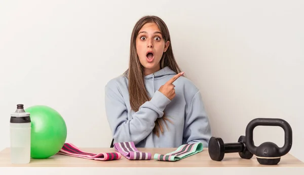 Young Caucasian Woman Sitting Table Sport Equipment Isolated White Background — Stock Photo, Image