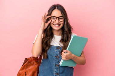 Young caucasian student woman isolated on pink background excited keeping ok gesture on eye.