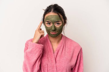 Young caucasian woman wearing a facial mask isolated on white background pointing temple with finger, thinking, focused on a task.