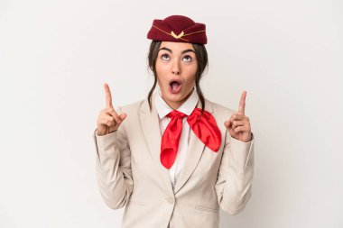 Young caucasian stewardess woman isolated on white background pointing upside with opened mouth.