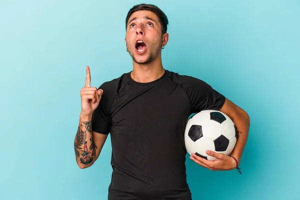 Young Man Playing Soccer Holding Ball Isolated Blue Background Pointing — 스톡 사진
