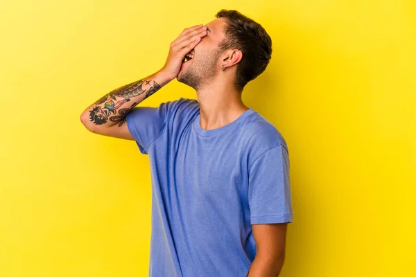 Young Caucasian Man Tattoos Isolated Yellow Background Laughing Happy Carefree —  Fotos de Stock