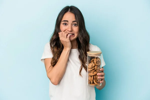 Young caucasian woman making a move isolated on yellow background biting fingernails, nervous and very anxious.