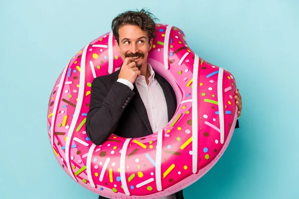 Young Business Man Inflatable Donut Isolated Blue Background Relaxed Thinking — 图库照片